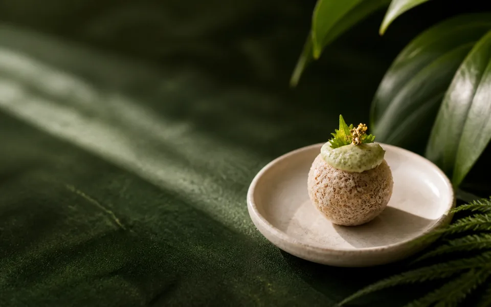 A sculptural Veggie Pop tasting bite in warm botanical light