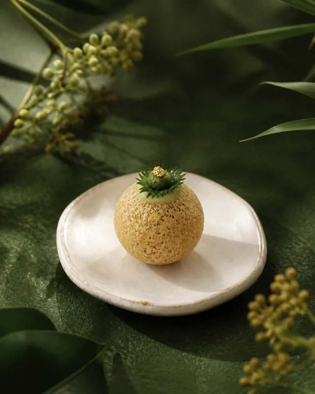 A crisp taro tofu bite with shiso cream on a handmade ceramic plate